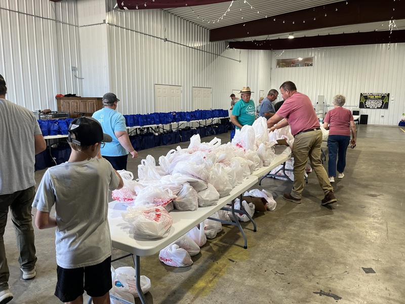 photo of volunteers preparing grocery to go bags for We Love White County