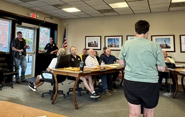 Jill Bradshaw addresses council while her husband Alderman Jack Bradshaw stares down Landon "Rudy" Rudolph