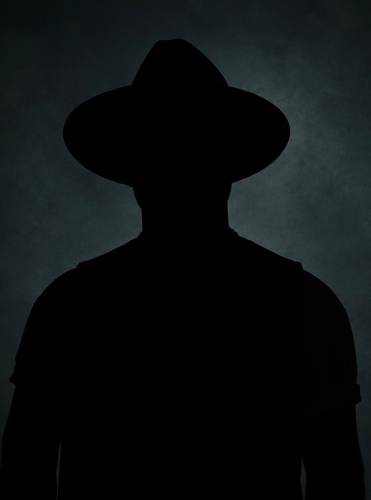 silhouette of man in a hat