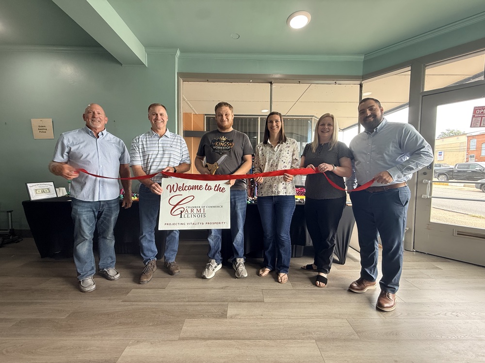 image of Carmi Chamber of Commerce representatives doing a ribbon cutting at King's Workshop